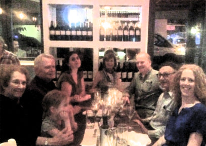 Photo of a family around a dinner table in a restaurant