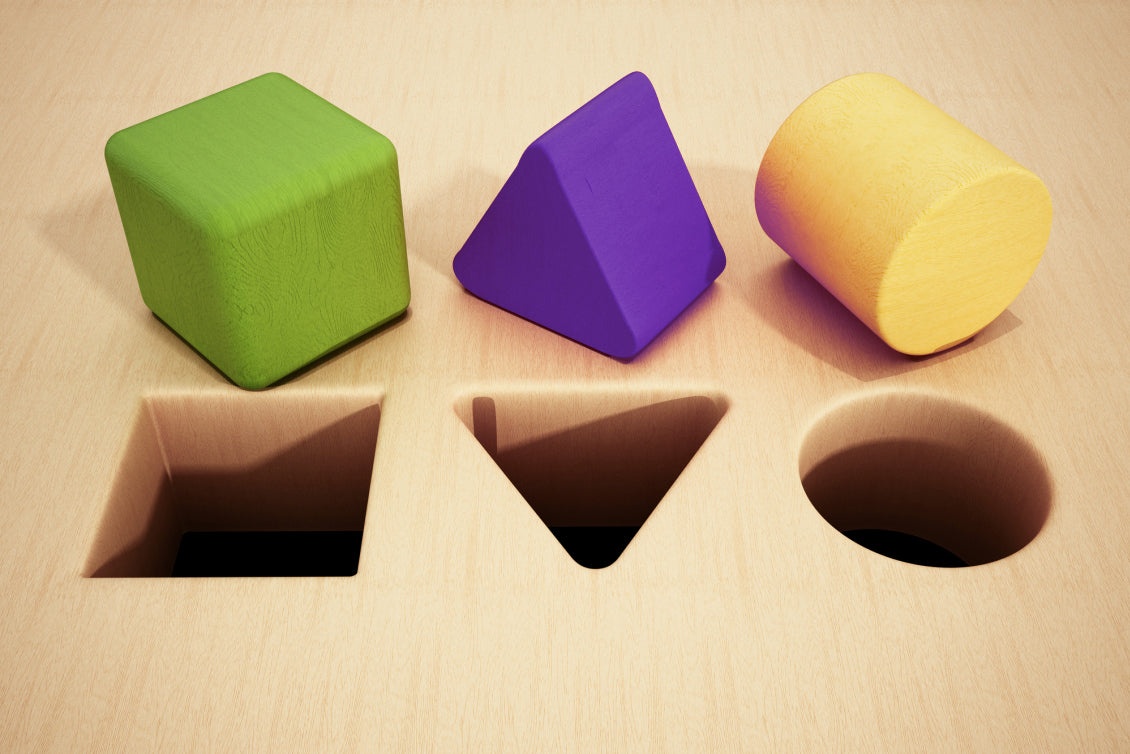 Block cube, triangle, column on wood plank with same shape holes in front of each one. Licensed from ShotShop.com 2022.
